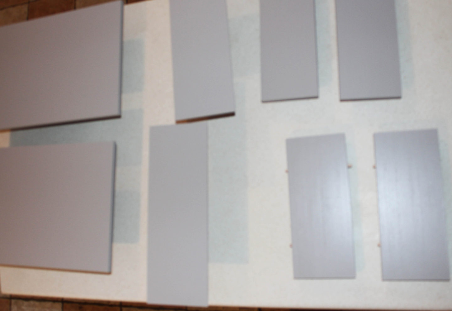 The pieces of the drawers freshly painted grey.