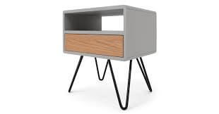 A grey bedside table with black hairpin legs