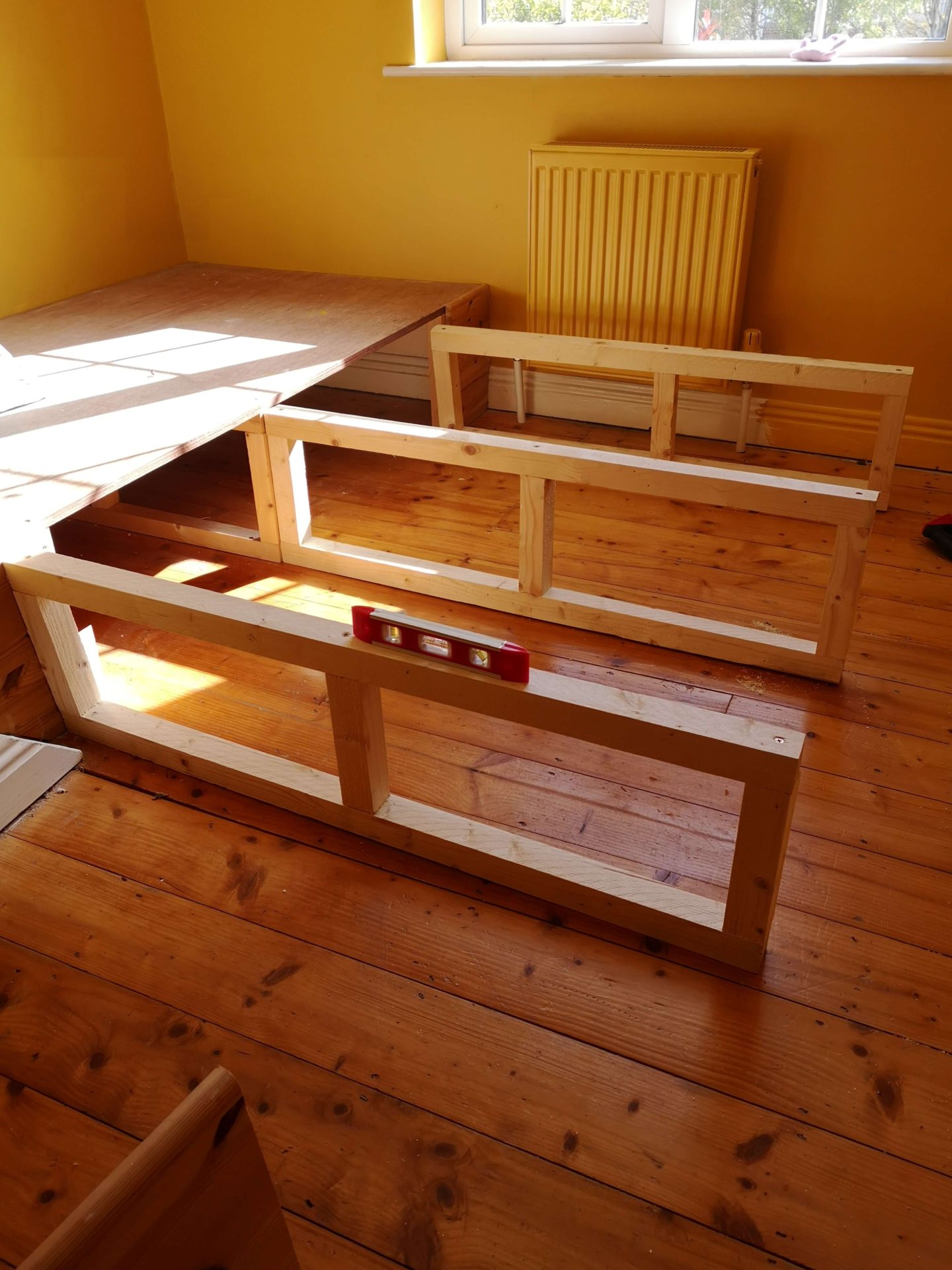 3 rectangular frames attached to an original single bed base. Creating the frame of the double bed base.