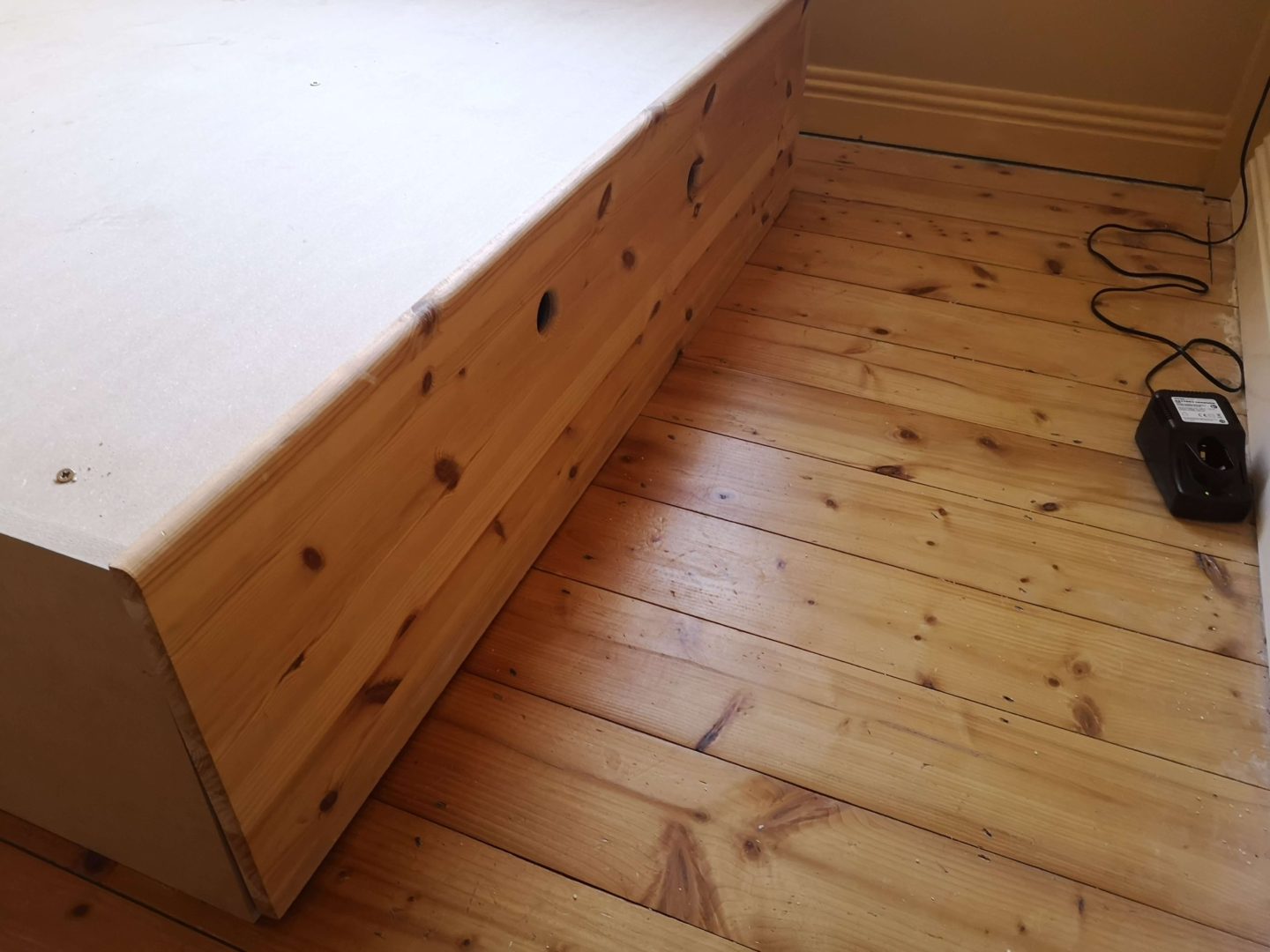 Two holes in the front panel of the bed, that can be used as handles.