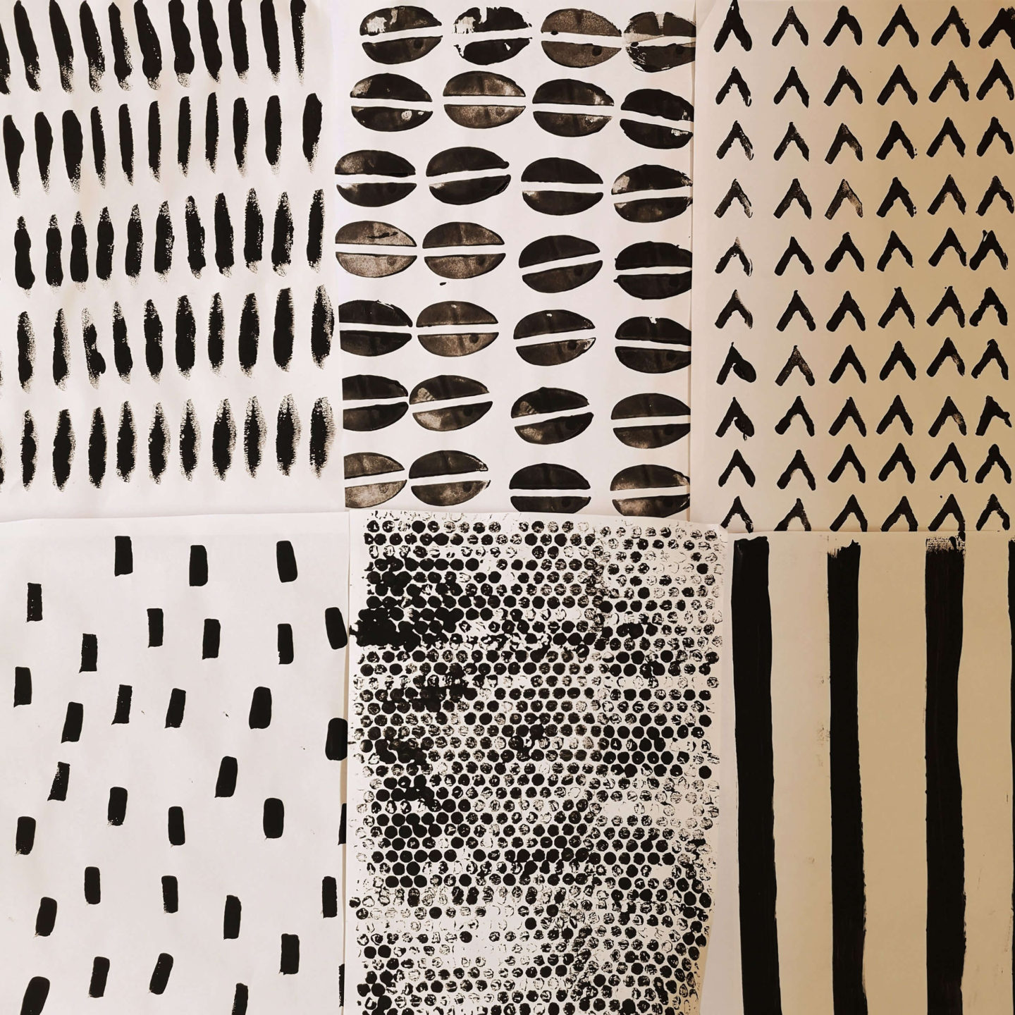 Samples of black printing on white fabric. Samples include stripes, bubble wrap print and rectangles.
