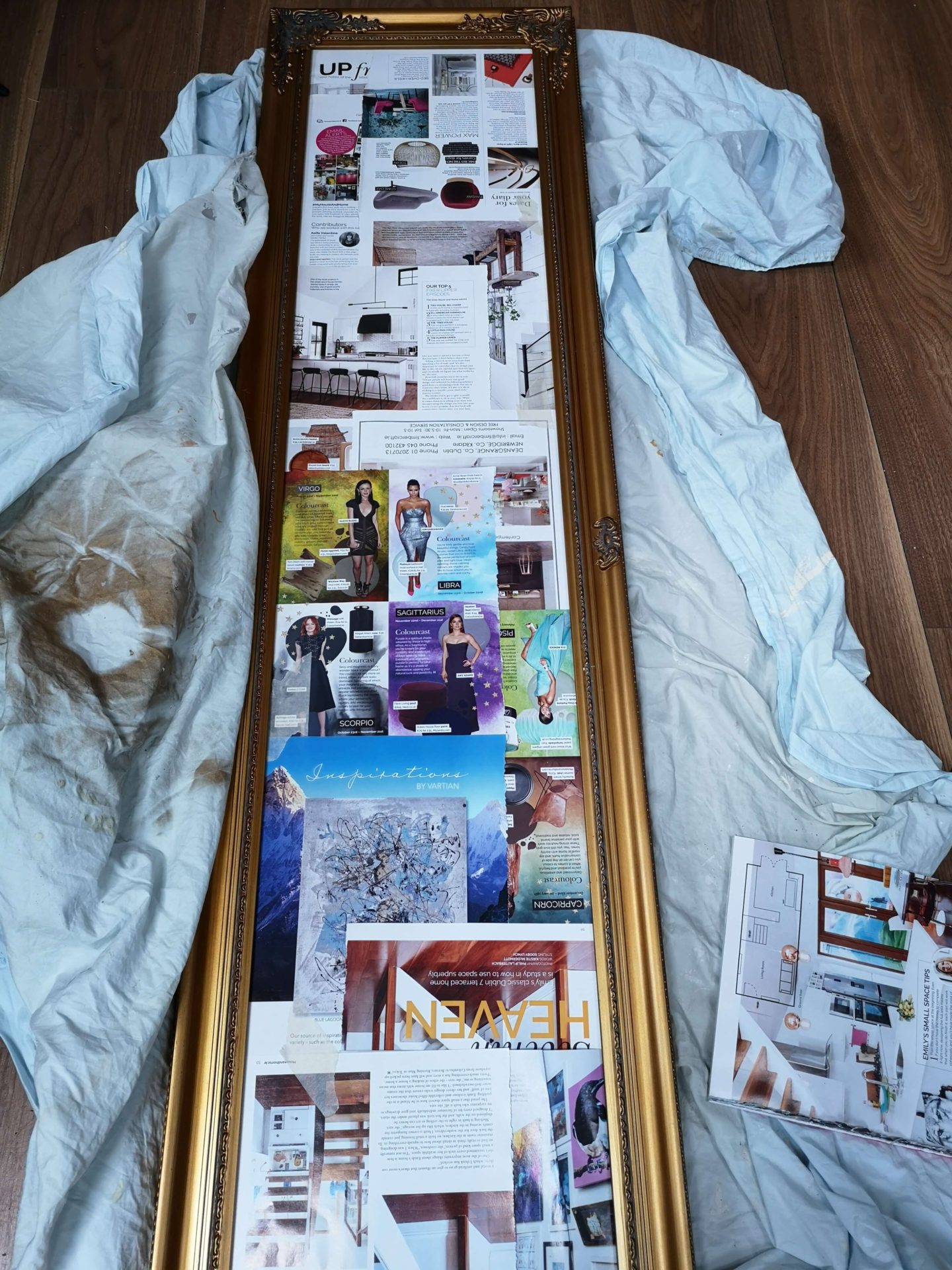 Mirror covered with protective magazine pages , leaving edges exposed for painting.