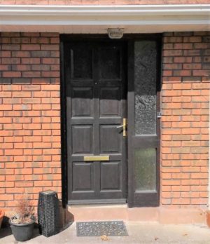 An old front door stained brown.