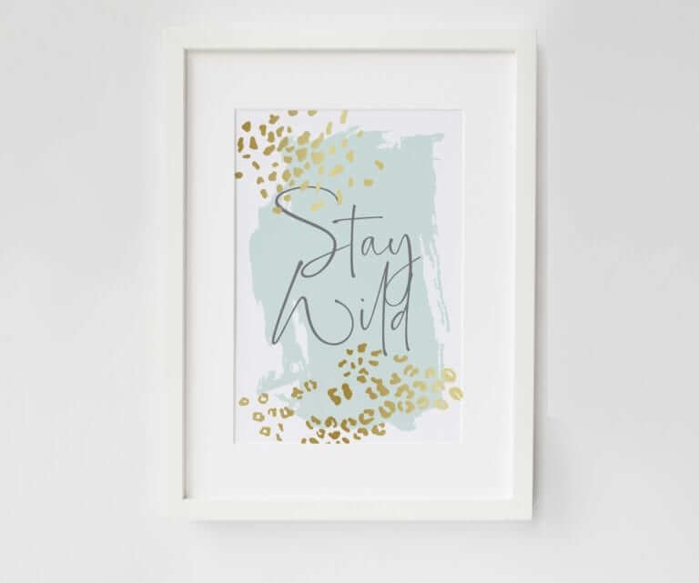 Print with the words Stay Wild written in dark grey. A green background with gold leopard spots near the corners.