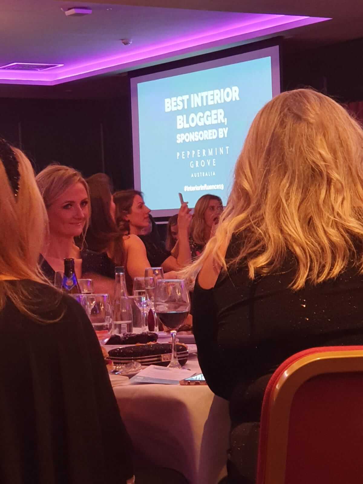 Photo of a screen announcing the winner of Best Interior Blogger. 