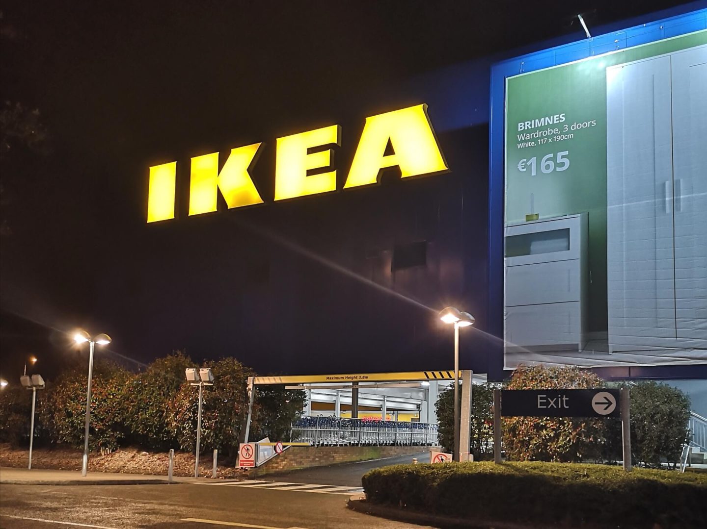 The exterior of the Ikea building in Dublin. A large, neon, yellow Ikea sign.