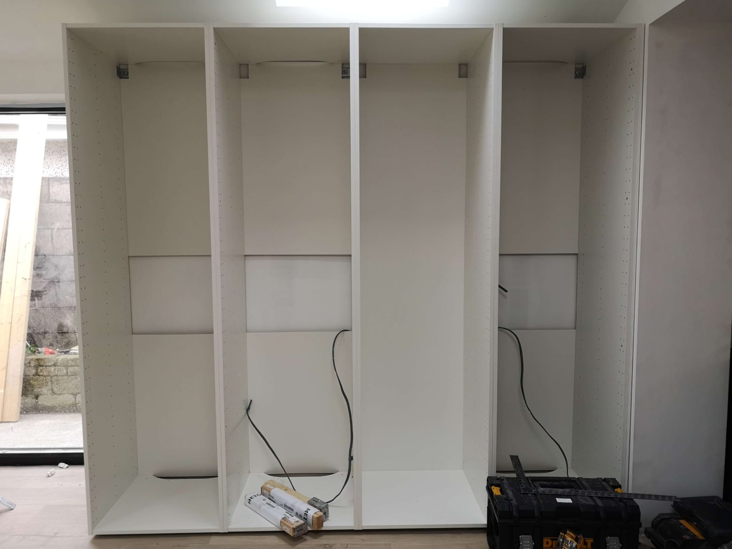 Four tall Ikea base cabinets secured into place.