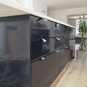 Black kitchen island cabinet with black drawer fronts. Ducktape is being used instead of handles.