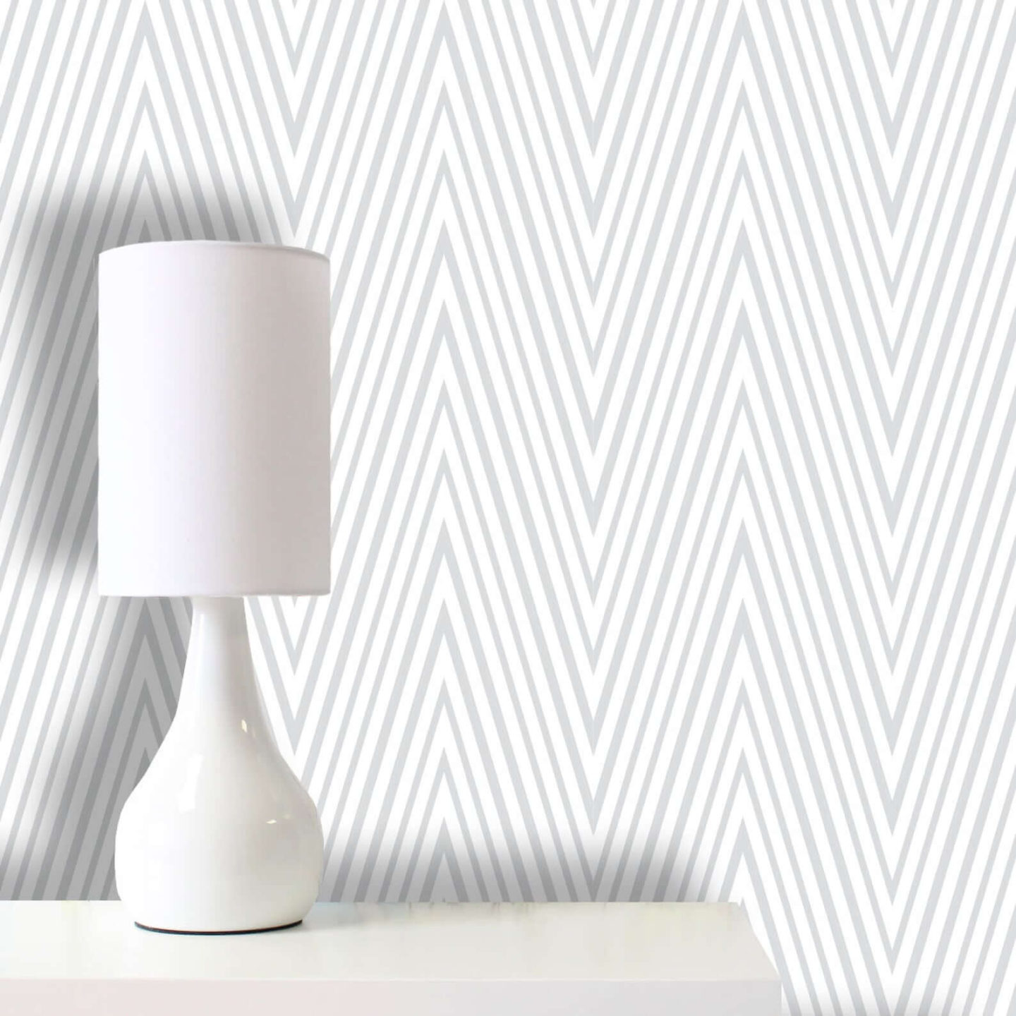 Grey and white peel and stick wallpaper in a zig-zag design.