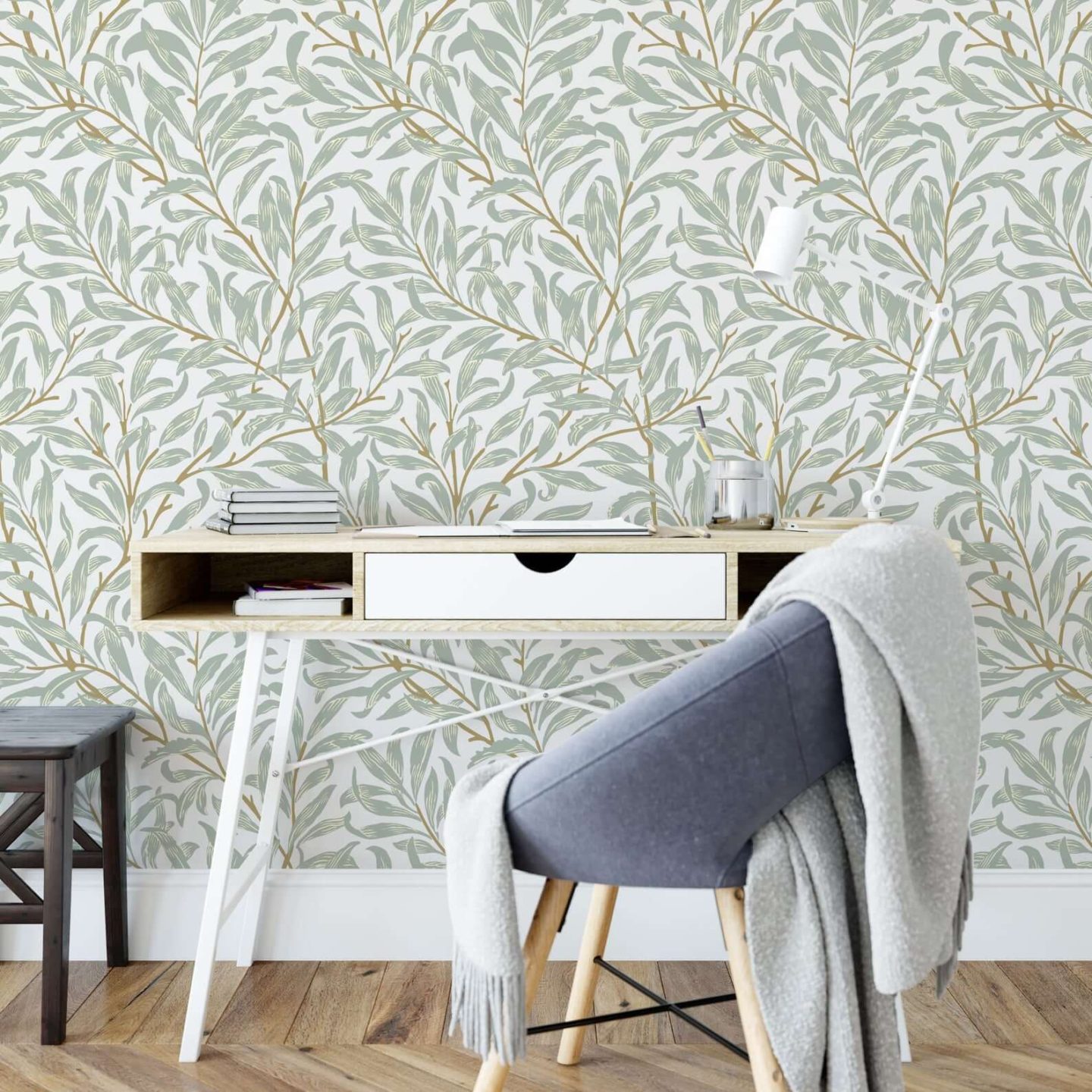 Peel and stick wallpaper with olive green leaves set against a cream background.