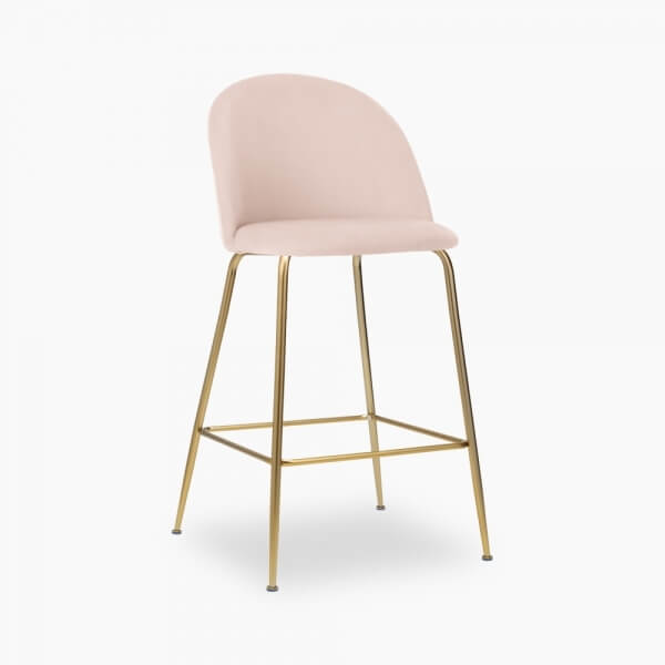 A pink velvet stool with brass legs.