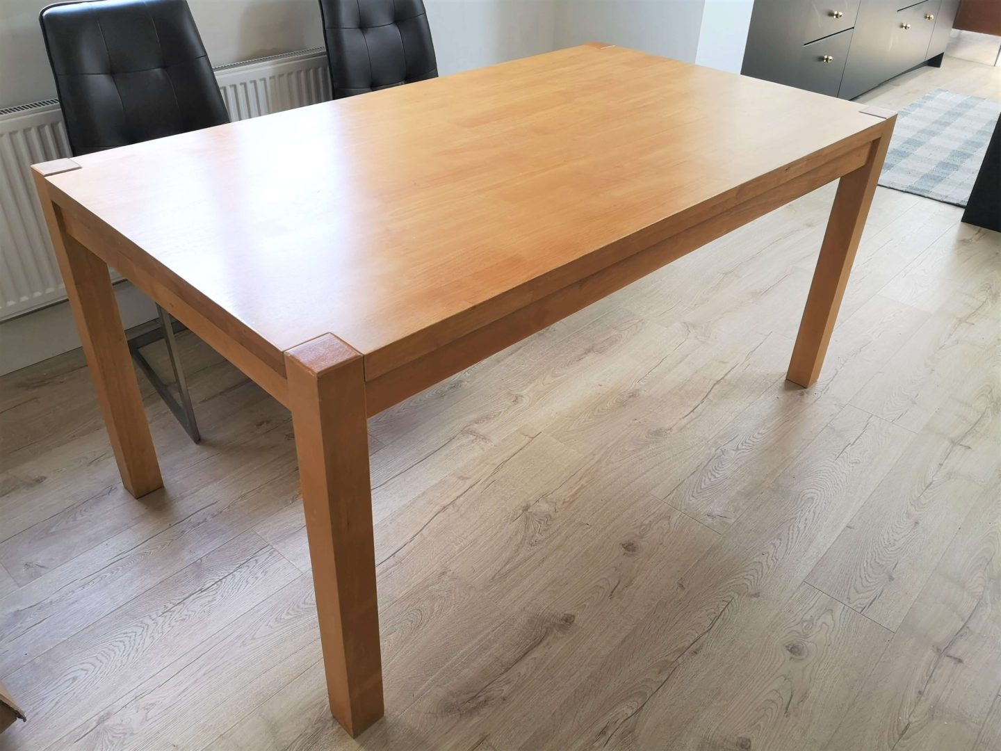 A kitchen table with an orange looking stain.