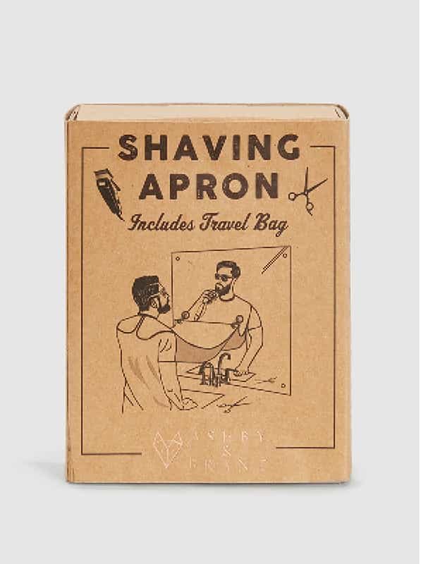 A brown vintage looking box with a shaving apron inside.