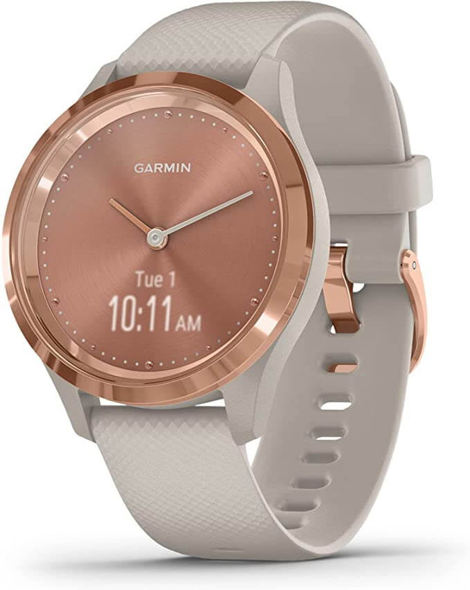A sports watch with a rose gold face and taupe strap.