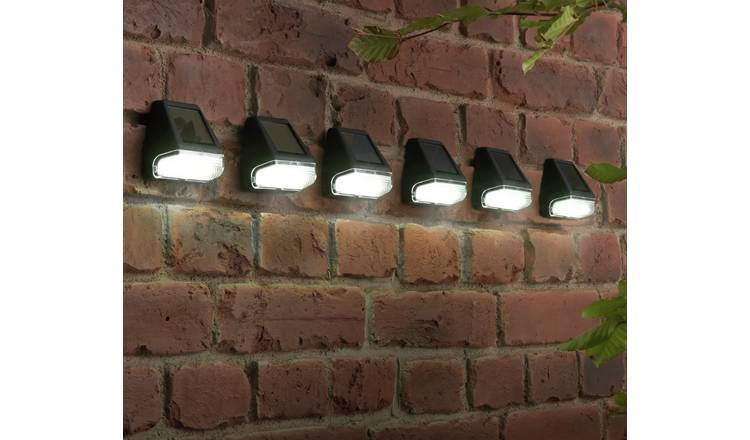 Six downlighters on a brick wall.