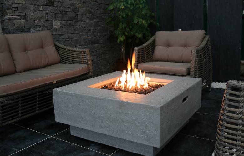 A square, grey gas firepit.