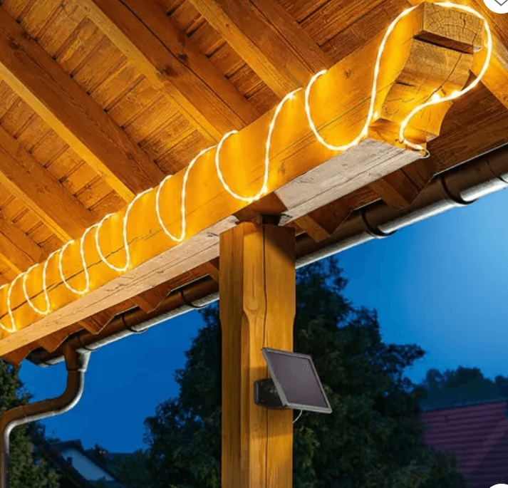 A rope light wrapped around a beam at night.