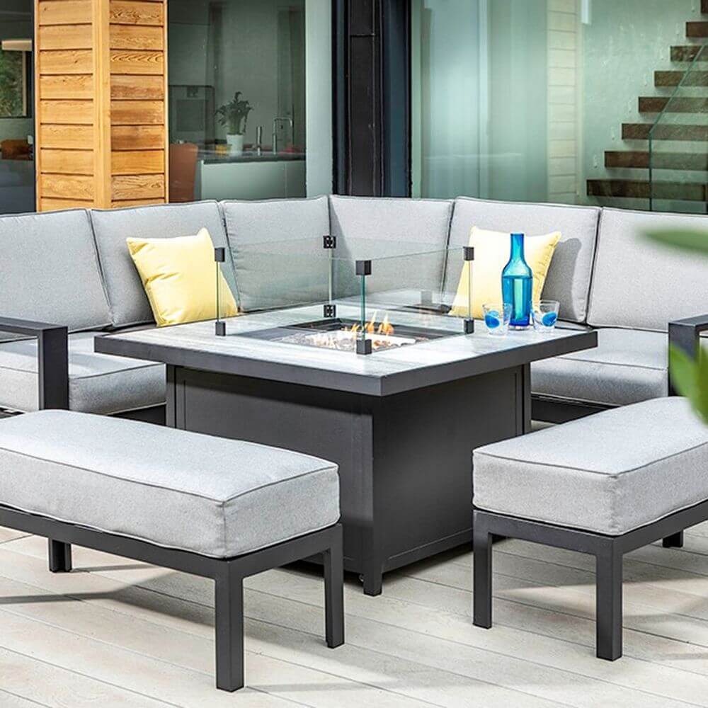 A black firepit table with seating for nine people.