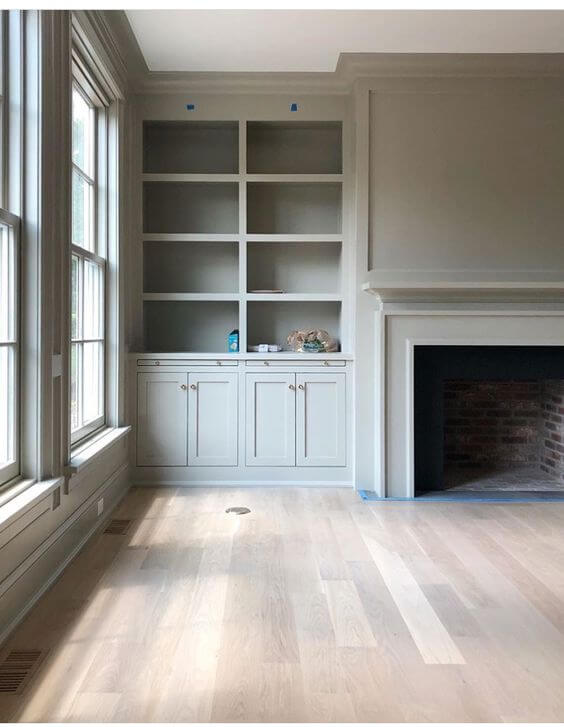 A living room being renovated. The walls and woodwork are all the same colour taupe.