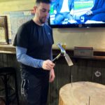 Trevor play the Hammer and Nails game in the bar.