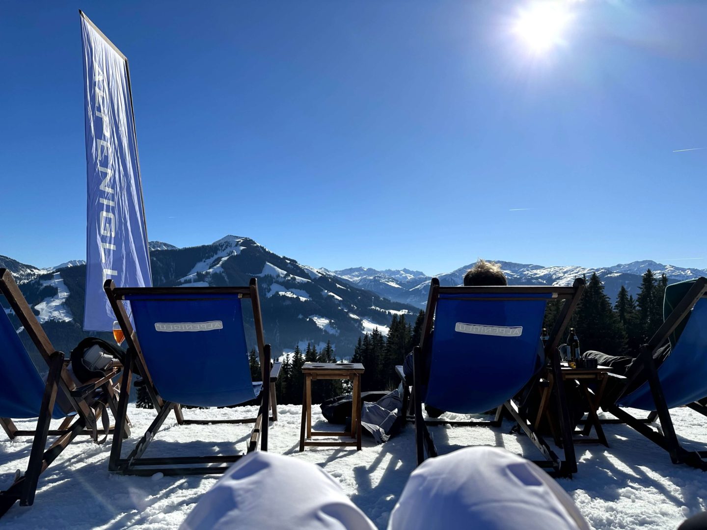 A view of a ski valley from sitting on a deck chair.
