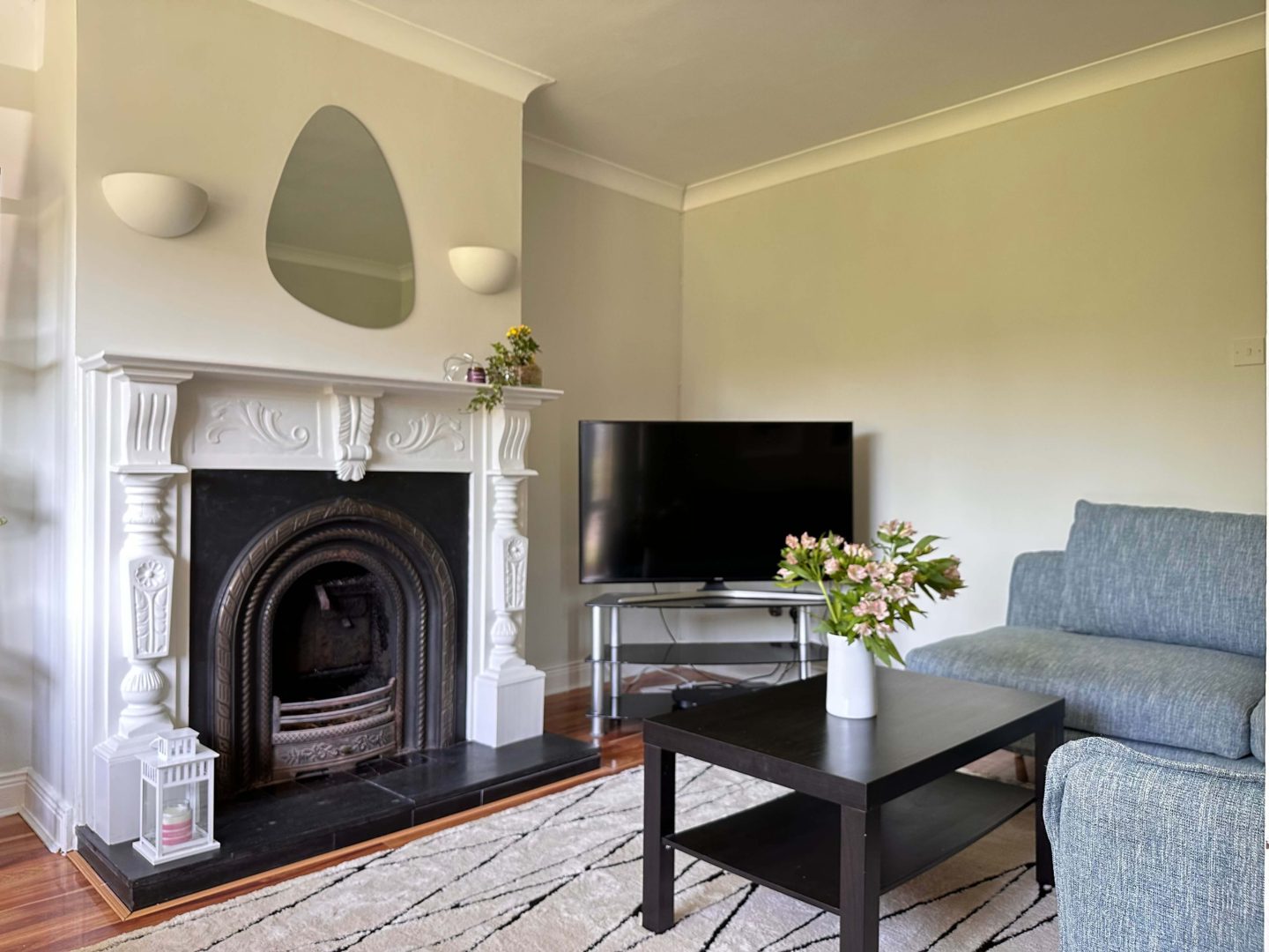 A living room with light green walls and a black coffee table.