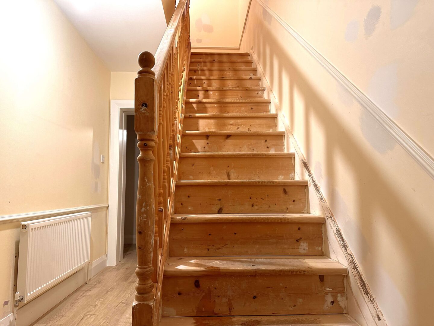 A wooden stairs filled, sanded and other prep work finished, ready for painting.